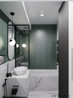 a modern bathroom with green and white tiles on the walls, tub, sink and mirror