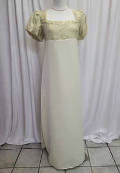 We offer a Regency styled gown, with the empire waist and short puffed sleeves.  This beautiful dress has a yellow embroidered lace overlay on the top and is fully lined.  The neckline has been trimmed with yellow lace trim.  The skirt is a solid pale yellow.      *This gown ties at the back with ribbons which can adjust the fit.      * All seams have been finished and this gown is spot clean or dry clean only.   If you have any questions about this dress, or any of our listings, please convo us White Short Sleeve Dress For Debutante Ball, Regency Style Empire Waist Dress For Debutante Ball, White Regency Style Formal Gown, Regency Empire Waist Dress For Debutante Ball, Cream Dress With Fitted Bodice And Empire Waist, White Regency Style Gown With Fitted Bodice, White Regency Gown With Fitted Bodice, Regency Style Empire Waist Wedding Maxi Dress, Empire Waist Fitted Gown For Evening