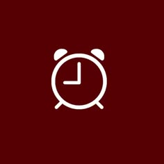 an alarm clock icon on a dark red background with the time is 11 00 pm