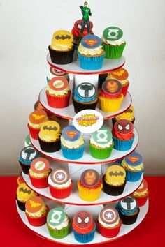 a three tiered cupcake stand with superheros on it