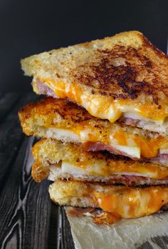 three grilled cheese sandwiches stacked on top of each other