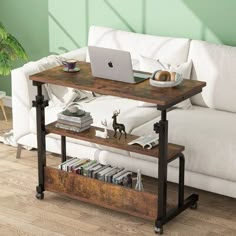 a living room with a white couch and a laptop on top of a wooden table