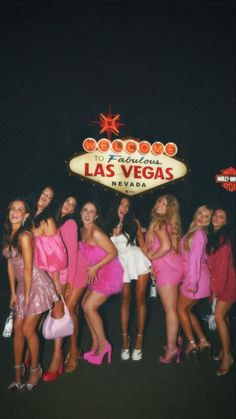 the girls are posing in front of the las vegas sign