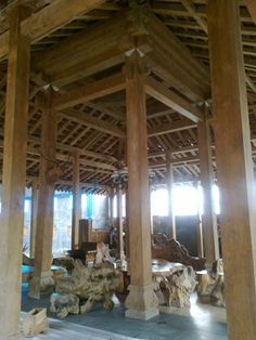 the inside of a building with wooden beams