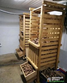 several wooden crates with potatoes in them sitting on the floor next to some other boxes