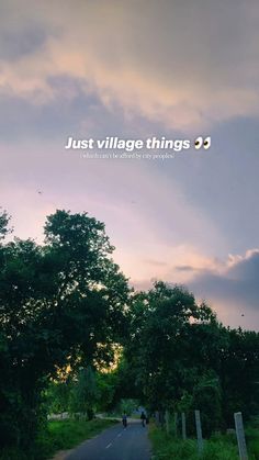 a person riding a bike down a road under a cloudy sky with the words just village things 3