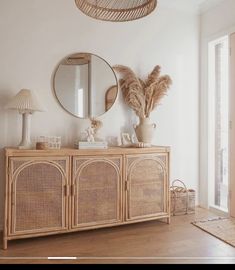 a white room with wicker furniture and mirrors