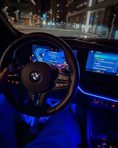 the interior of a car is lit up with blue lights and features an electronic touch screen