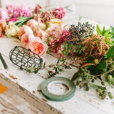 flowers are laid out on an old table