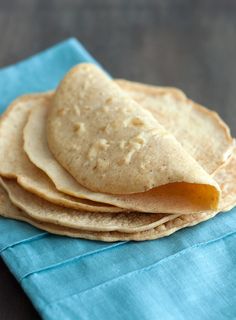 a stack of tortillas sitting on top of a blue napkin