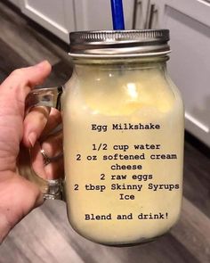 a person holding a mason jar with an egg milkshake in it and instructions on the inside