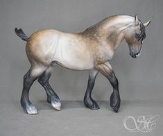 a statue of a horse on a gray background