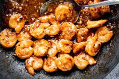 a skillet filled with cooked shrimp and sauce