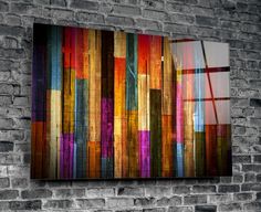 an abstract painting on a brick wall