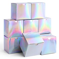 several boxes with holographics on them are stacked in the shape of cubes