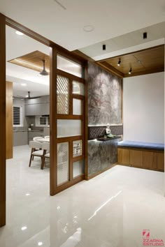 an open door leading into a room with white tile flooring and wood trimming