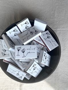 a black bowl filled with lots of cards on top of a table