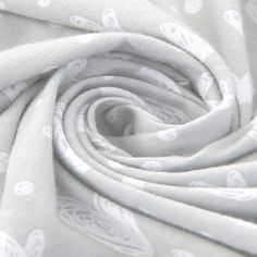 the fabric is white and has an intricate design on it, as well as many other things