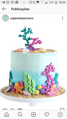 there is a cake decorated with sea life on the top and under it's icing