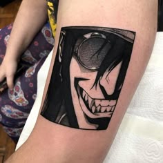 a person with a black and white tattoo on their arm that has an image of the joker