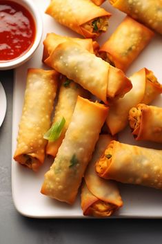 some food is on a white plate with dipping sauce