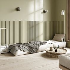 a living room with white furniture and green walls