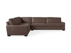 a brown sectional couch sitting on top of a white floor