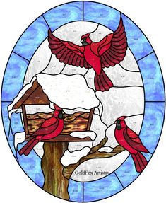 two red birds sitting on top of a bird feeder in front of a blue stained glass window