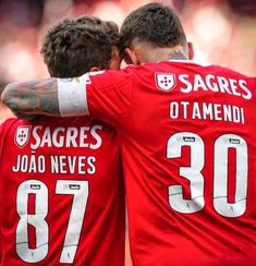 two soccer players are hugging each other on the field