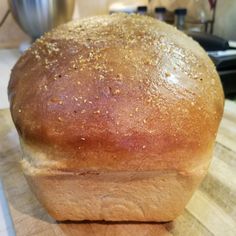 a loaf of bread sitting on top of a wooden cutting board