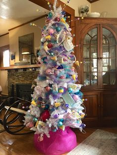 a brightly colored christmas tree in a living room