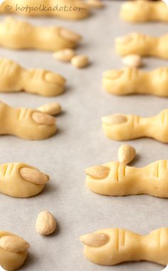 peanut butter hand and foot shaped cookies on a baking sheet, ready to go into the oven