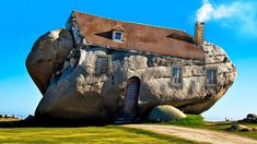 a large rock with a house built into it