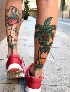 a woman's legs with tattoos on them and a flamingo in the palm tree