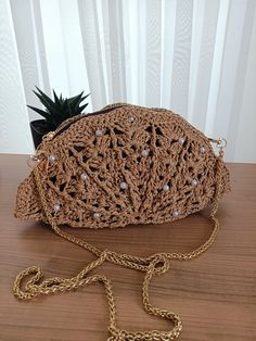 Oyster style raffia shoulder bag, shell likte bag, natural straw tote handbag, eco friendly paper yarn bag Perfect oyster style bag knitted by hand from boho style raffia. It is very trendy and made of handmade natural threads. Its mussel like shape and beige color looks cool with gold-colorde metal strap. Because of the its naive shell shaped you can remove strap and use as a clutch bag. It is very stylish bag and ready for shipping. The size and color of the raffia might be slightly different Chic Beige Braided Crochet Bag, Elegant Handwoven Beach Bag, Summer Beach Crochet Clutch Bag, Elegant Jute Crochet Bag For Spring, Elegant Handwoven Crochet Bag For The Beach, Summer Vacation Crochet Clutch Bag, Summer Crochet Beach Clutch, Elegant Crochet Jute Bag For Spring, Elegant Natural Shoulder Bag For The Beach