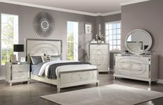 a bedroom with gray walls and white furniture