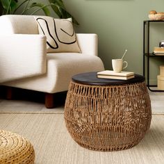 a coffee table with a cup on it in a living room next to a couch