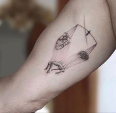 a woman's arm with some drawings on it and an arrow in the middle