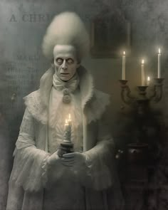 a creepy man holding a lit candle in his hands