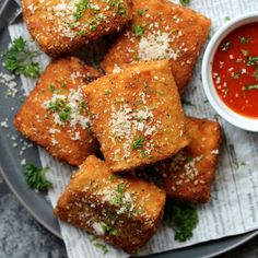 some food is sitting on a plate with dipping sauce