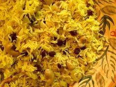 yellow rice with raisins and nuts in a bowl