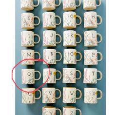 coffee mugs are arranged in the shape of letters