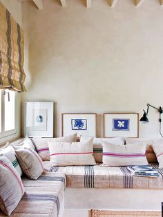 a living room filled with furniture and pictures on the wall