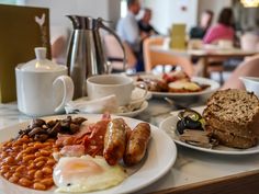 a table topped with plates of breakfast food