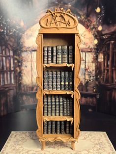 a wooden book shelf with many books on it's shelves and an ornately decorated wall behind it