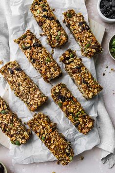 homemade granola bars are lined up on parchment paper