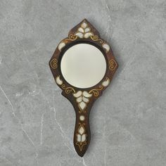 a mirror sitting on top of a stone floor