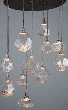 a bunch of lights that are hanging from a light fixture with ice cubes on them