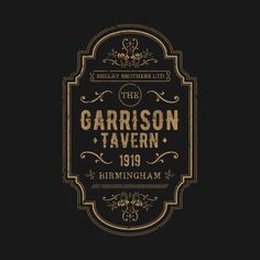 the garrison tavern logo on a black background with gold lettering and an ornate frame