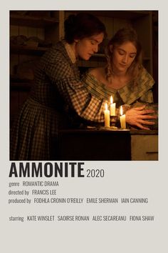 two women are looking at a candle in front of the poster that says ammonite